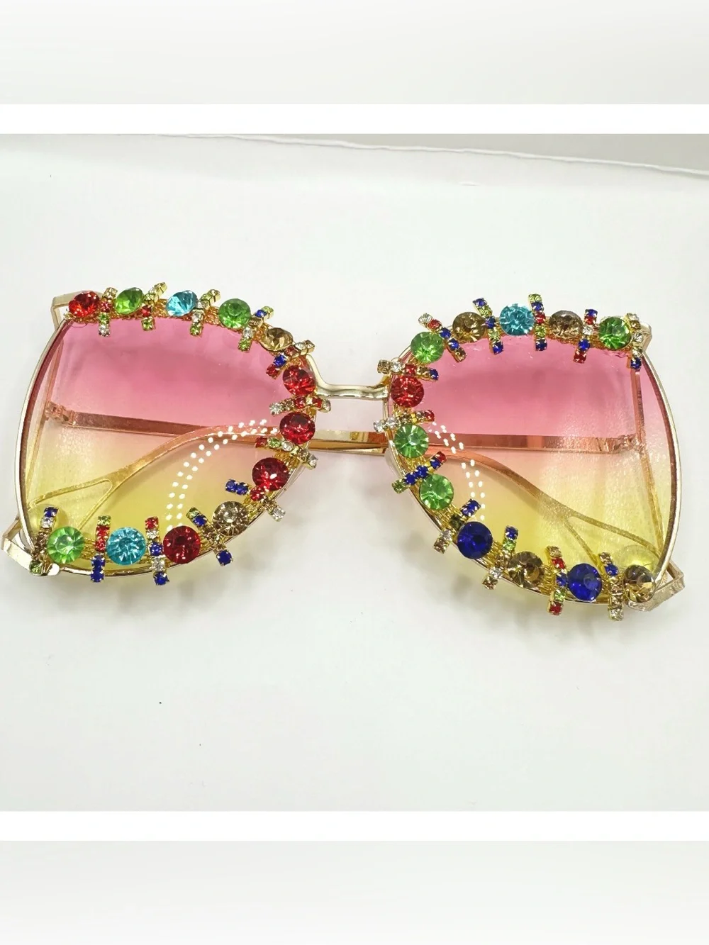 Oversized gold-frame party sunglasses featuring vibrant pink-to-yellow gradient